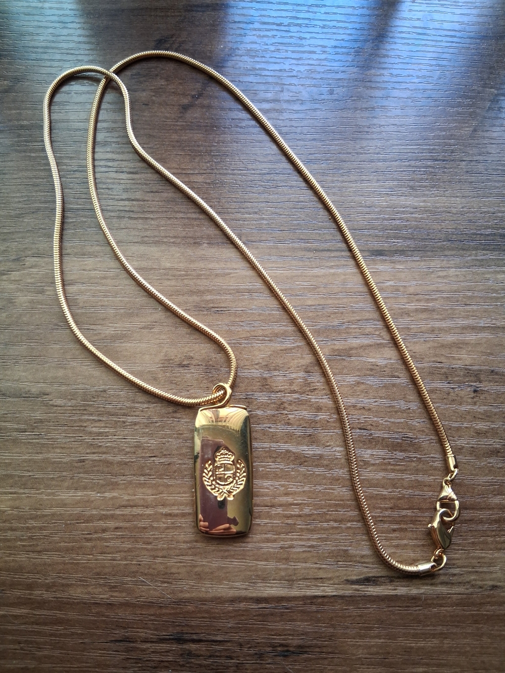 Vintage Liz Claiborne Gold-Tone Ingot Necklace Featuring A Crest Logo